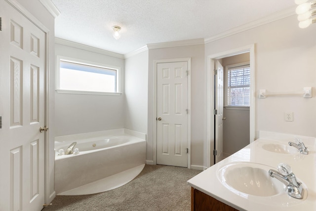 bathroom featuring a garden tub, a sink, a textured ceiling, and double vanity