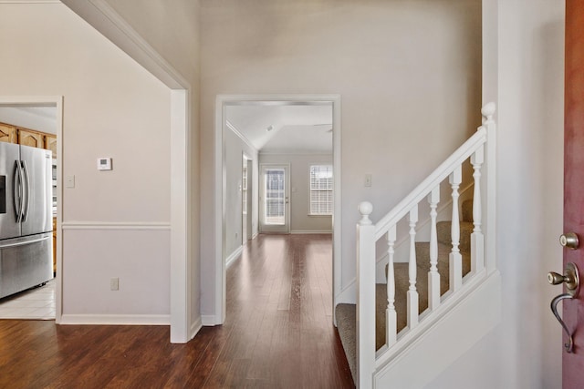 entrance foyer featuring stairs, ornamental molding, wood finished floors, and baseboards