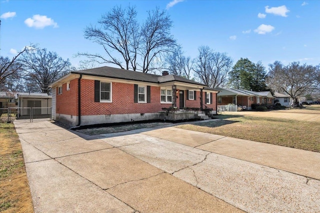 single story home with brick siding, concrete driveway, crawl space, a front lawn, and a chimney