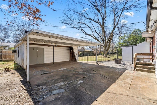 garage featuring fence and a detached garage