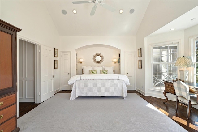 bedroom with baseboards, dark wood finished floors, ceiling fan, high vaulted ceiling, and recessed lighting