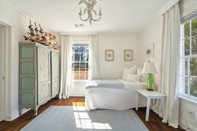 bedroom featuring an inviting chandelier, baseboards, ornamental molding, and dark wood finished floors