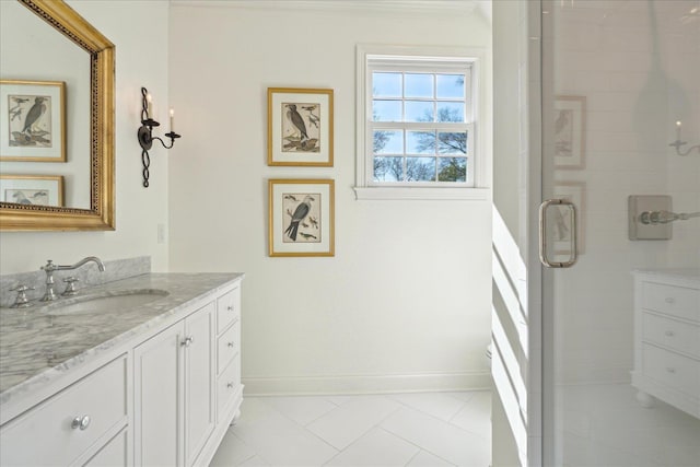 full bath featuring a stall shower, vanity, and baseboards