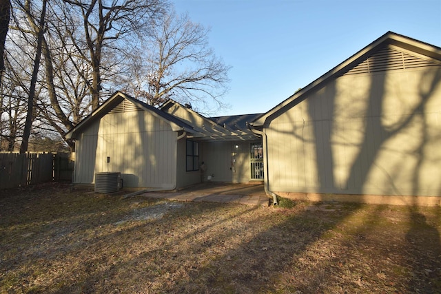 rear view of property with fence and central air condition unit