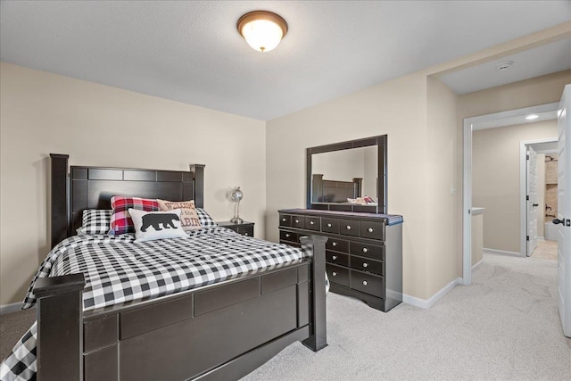 bedroom with baseboards and light carpet