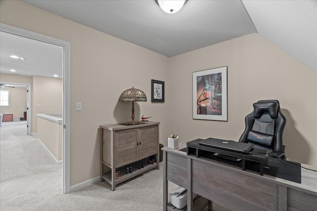 office with lofted ceiling, baseboards, a textured ceiling, and carpet floors