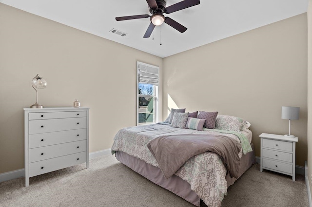 carpeted bedroom featuring visible vents, baseboards, and a ceiling fan