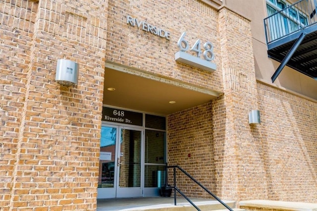 property entrance with brick siding