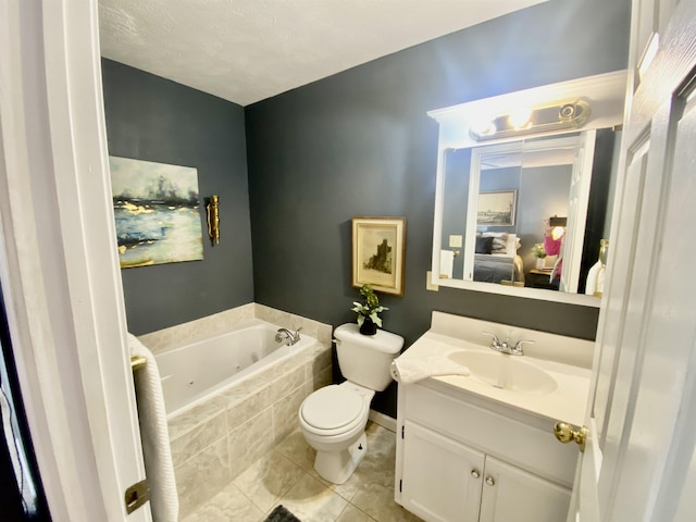 ensuite bathroom featuring connected bathroom, toilet, a tub with jets, tile patterned flooring, and vanity