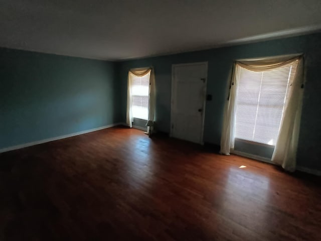 interior space featuring baseboards and wood finished floors