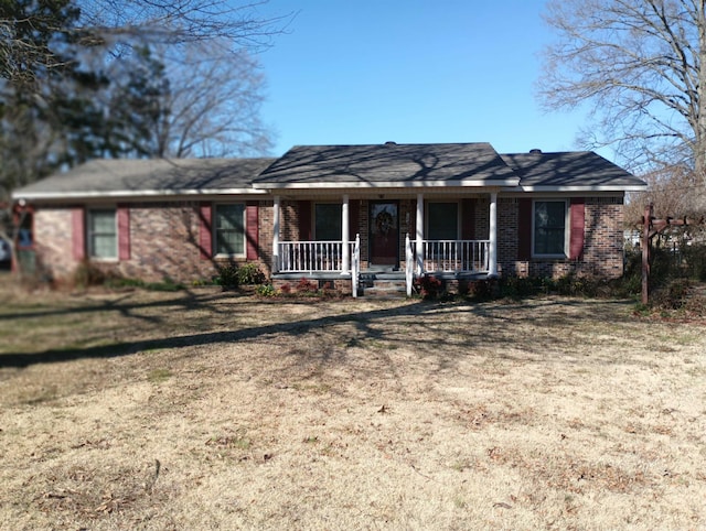 ranch-style house with a porch and brick siding