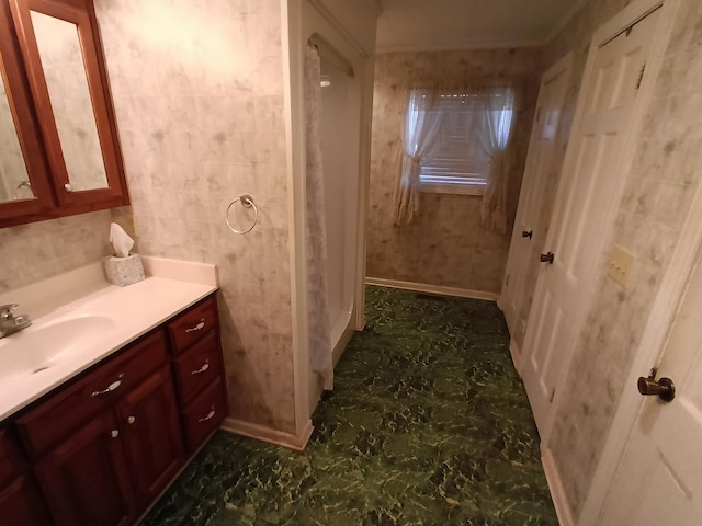 bathroom featuring baseboards and vanity