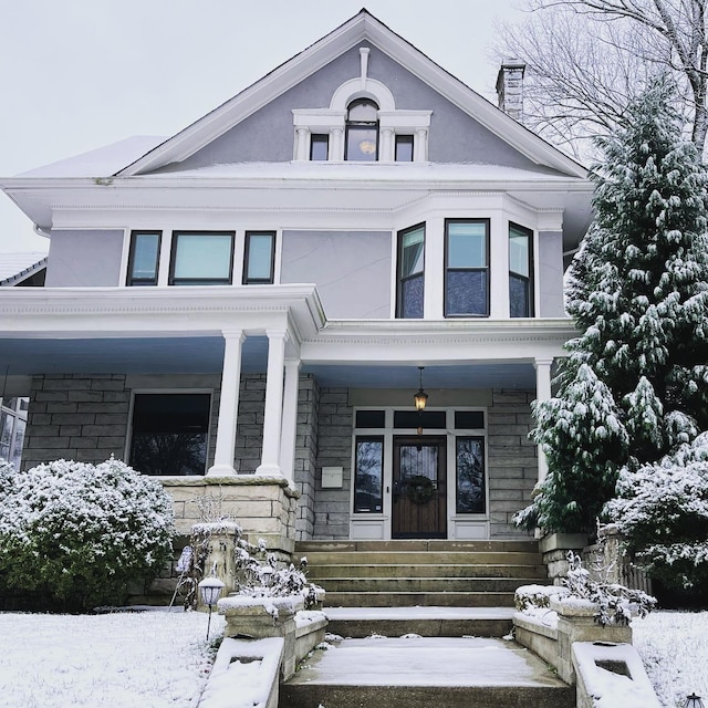 view of front facade featuring a porch and stucco siding