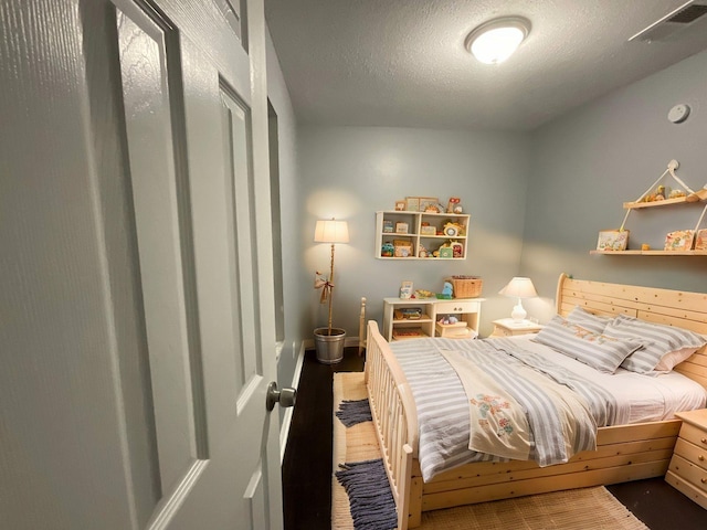 bedroom with visible vents and a textured ceiling