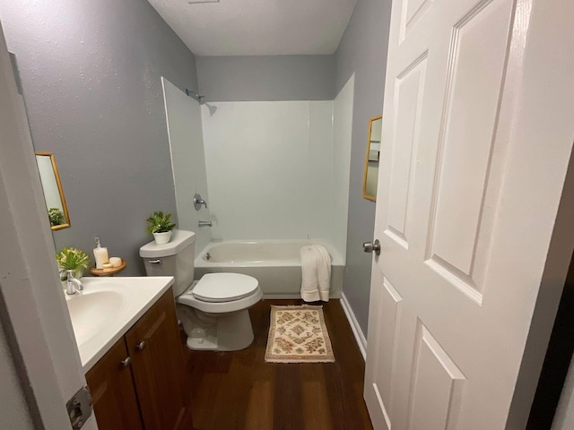 bathroom featuring toilet, shower / bath combination, wood finished floors, and vanity