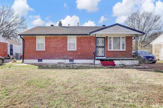 view of front of property featuring a front yard, a chimney, and brick siding