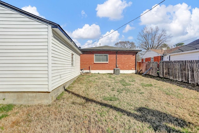 view of yard with cooling unit and fence