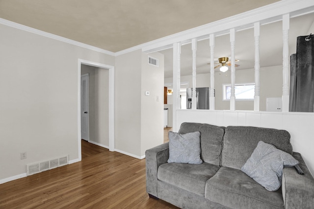 living area featuring ceiling fan, wood finished floors, visible vents, and baseboards