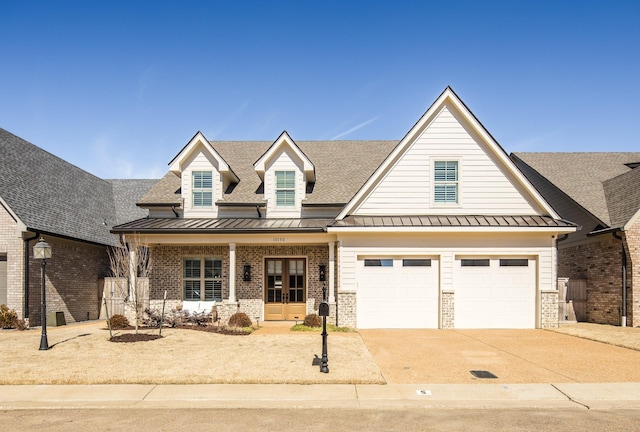 view of front of house with driveway, brick siding, a standing seam roof, and roof with shingles