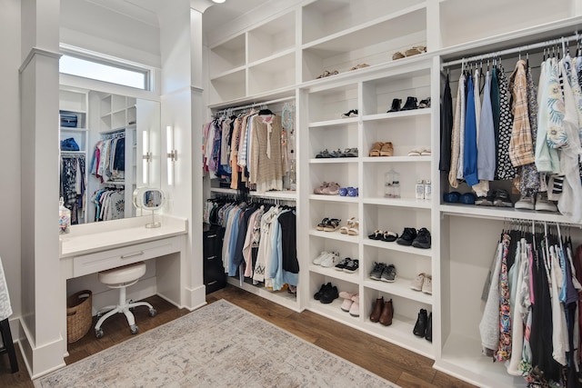 walk in closet with wood finished floors