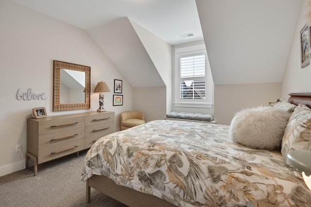 carpeted bedroom featuring baseboards, visible vents, and vaulted ceiling