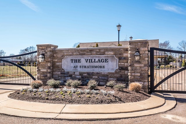 community sign featuring a gate