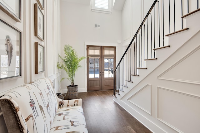 foyer entrance with dark wood-style floors, visible vents, a wealth of natural light, and french doors