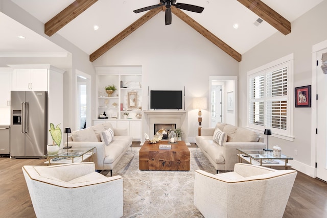 living area with high vaulted ceiling, beam ceiling, and wood finished floors