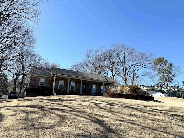 view of front of property with brick siding and a front lawn