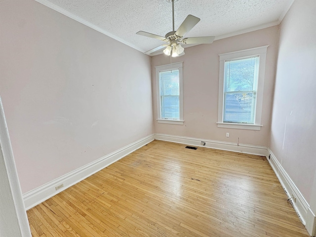 spare room featuring a ceiling fan, a textured ceiling, and light wood finished floors