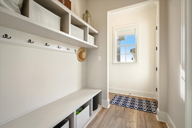 mudroom featuring light wood-type flooring and baseboards