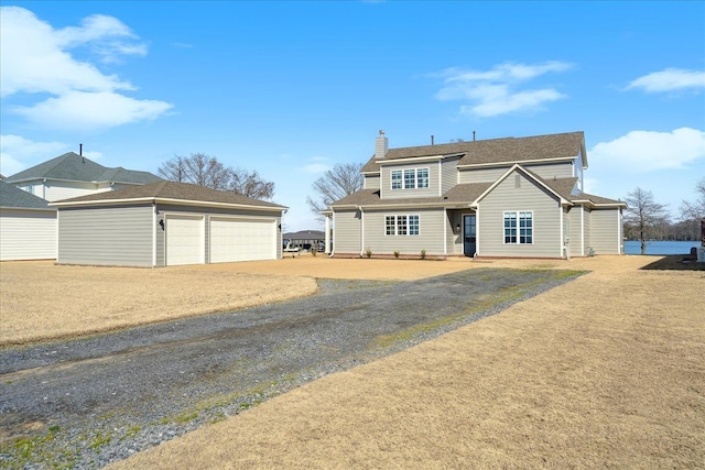 view of front of home featuring an outdoor structure and a chimney