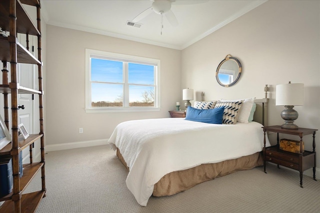 carpeted bedroom featuring a ceiling fan, baseboards, visible vents, and crown molding