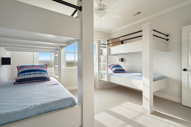 bedroom with carpet flooring, a ceiling fan, visible vents, baseboards, and ornamental molding