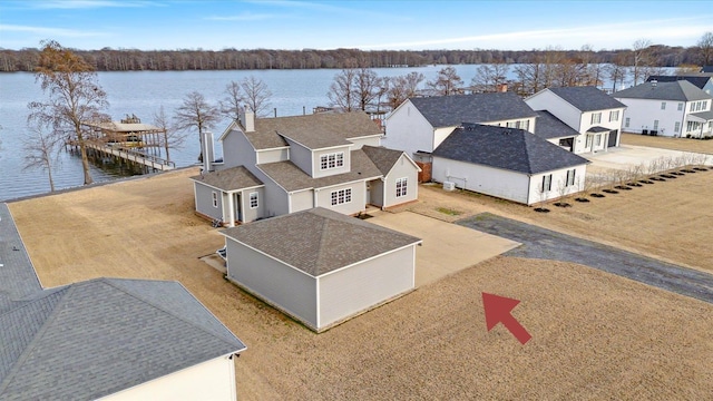 drone / aerial view featuring a water view and a residential view