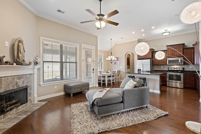 living room featuring a fireplace, visible vents, and ornamental molding