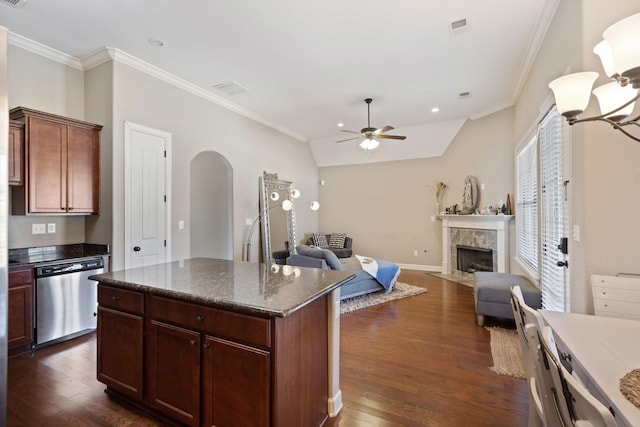 kitchen with dishwasher, a tiled fireplace, arched walkways, and dark wood finished floors