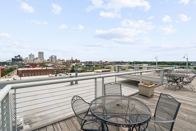 deck with a view of city and outdoor dining area