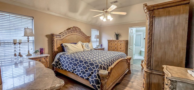 bedroom with dark wood finished floors, visible vents, ornamental molding, ceiling fan, and ensuite bath