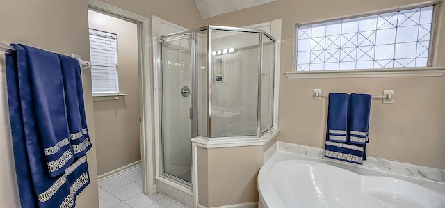 bathroom featuring tile patterned flooring, a shower stall, and a bath