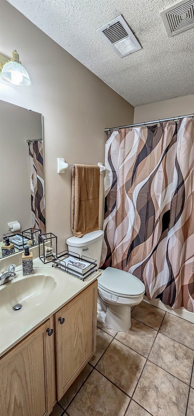 full bath with a textured ceiling, toilet, vanity, and visible vents