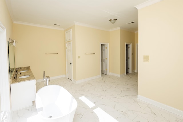 bathroom featuring baseboards, visible vents, ornamental molding, marble finish floor, and a freestanding tub