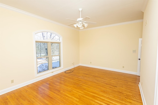 unfurnished room with light wood finished floors, baseboards, ornamental molding, and ceiling fan