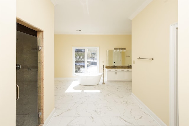 bathroom featuring marble finish floor, baseboards, crown molding, and vanity