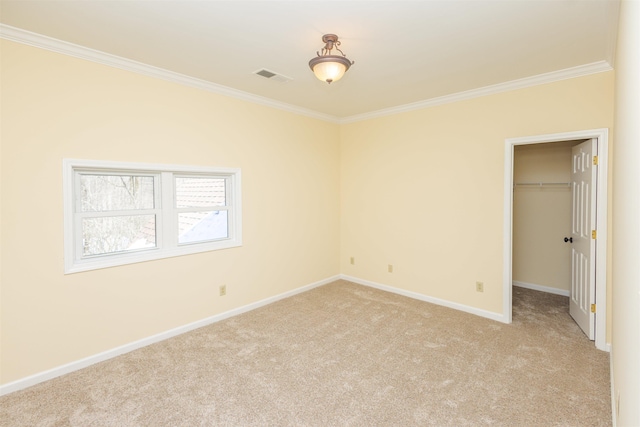 interior space featuring baseboards, ornamental molding, visible vents, and light colored carpet