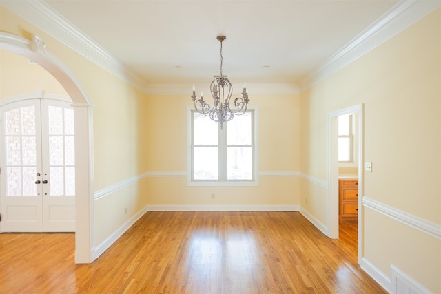 spare room featuring a chandelier, visible vents, baseboards, french doors, and light wood finished floors