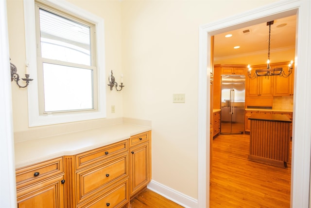 hall featuring baseboards, crown molding, light wood-type flooring, a notable chandelier, and recessed lighting