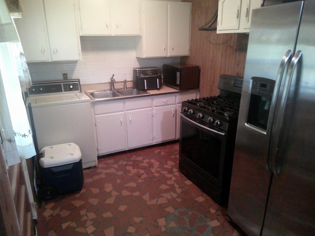 kitchen featuring a sink, white cabinetry, light countertops, black appliances, and washer / clothes dryer