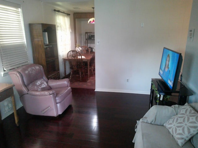 living area with hardwood / wood-style floors and baseboards