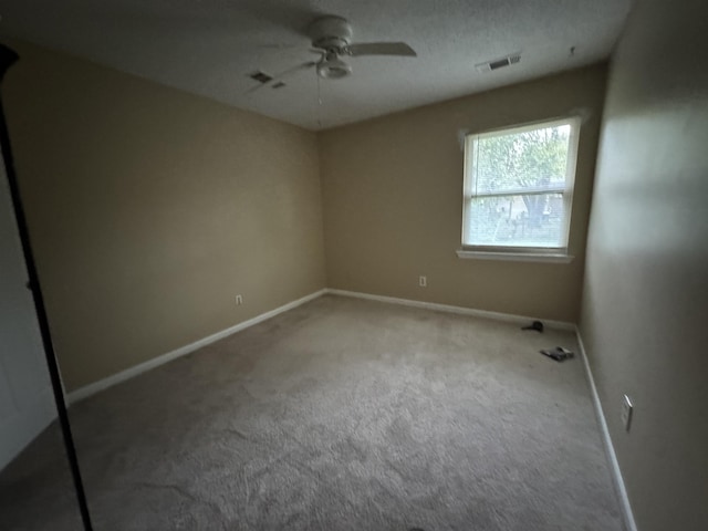 unfurnished bedroom with baseboards, visible vents, a ceiling fan, and carpet flooring